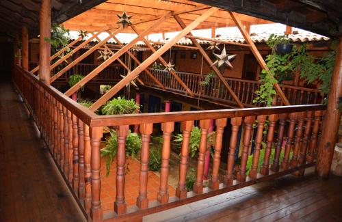 a wooden railing on a porch with a building at La Vieja Casona Hotel in La Manzanilla