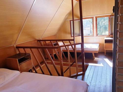 a small room with two beds and a staircase at Chatový tábor Malý Ratmírov in Malý Ratmírov