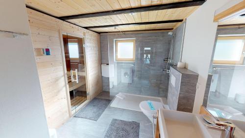 a bathroom with a shower and a toilet and a sink at Swantee in Belalp