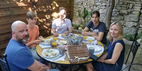 a group of people sitting around a table eating food at Maison Carles BnB in La Colle-sur-Loup