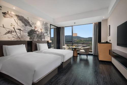 Postel nebo postele na pokoji v ubytování Fuzhou Mawei Yiho Hotel