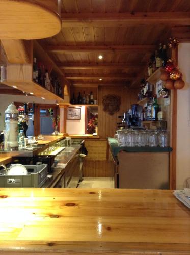 a kitchen with a wooden counter top in a restaurant at Hotel Soldeu Maistre in Soldeu