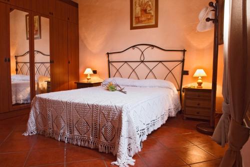 a bedroom with a bed with a white bedspread at Casa Rural La Furnia in Icod de los Vinos