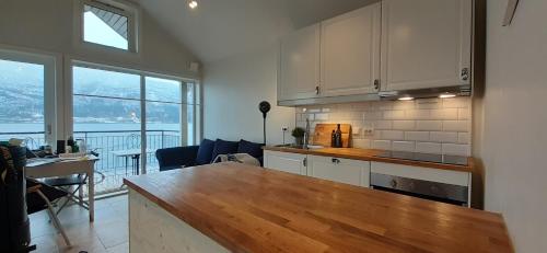 a kitchen with a counter top and a table in a room at Fjord Paradise Stryn in Stryn