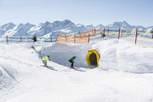 a group of people skiing down a snow covered slope at Gästehaus Flörl in Gerlosberg