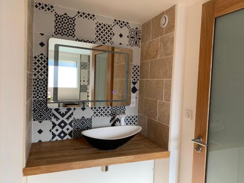 uma casa de banho com um lavatório e um espelho em ATELIER 85 em Les Épesses