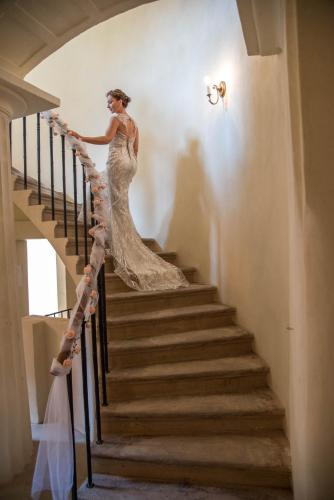 a woman walking down a staircase in a wedding dress at Penzion U Synagogy in Jičín