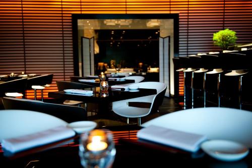 a restaurant with tables and chairs in a room at Park Plaza London Westminster Bridge in London