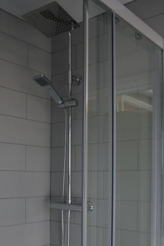 a shower with a glass door in a bathroom at The Five Pilchards Inn in Helston