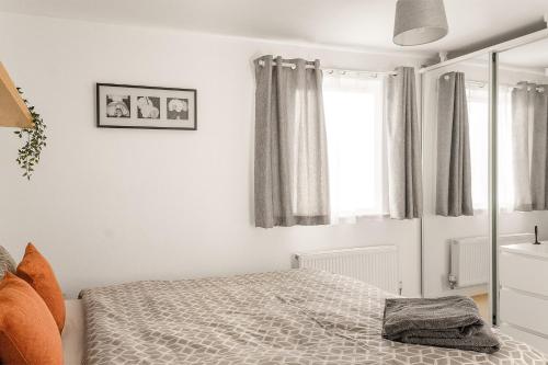 a white bedroom with a bed and a window at Leap Onyx Apartment - Northampton Town Centre in Northampton