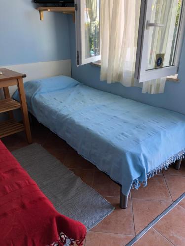 a bed sitting in a room next to a window at Apartman Ana in Umag