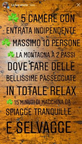 a sign on a wooden wall with the names of differentiterraneaniterraneaniterraneaniterraneaniterranean at Valle dei Mulini B&B in Marciana