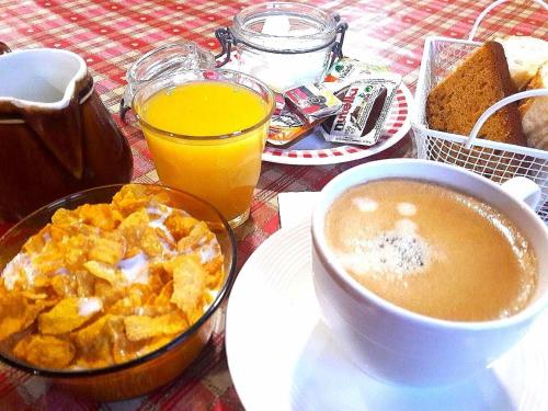 a table with a bowl of cereal and a cup of coffee at Le Chamoniard Volant in Chamonix-Mont-Blanc