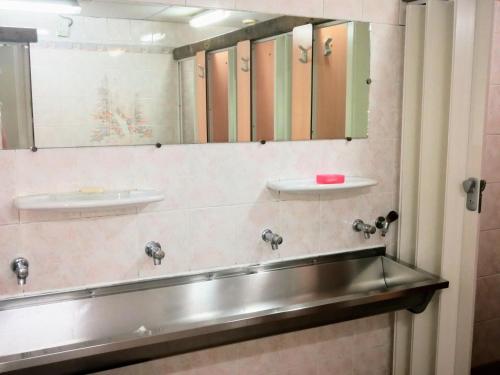 a bathroom with two sinks and mirrors on the wall at Le Chamoniard Volant in Chamonix-Mont-Blanc