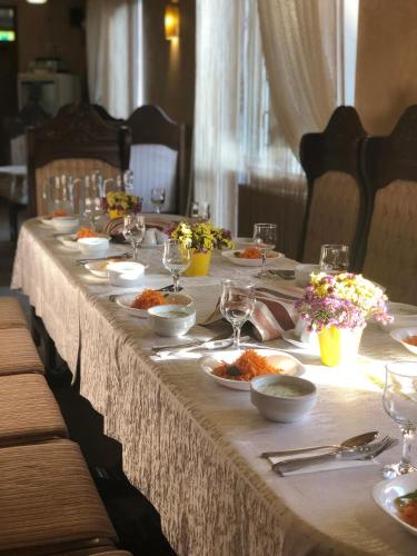 a long table with plates of food on it at Карпаты in Khust