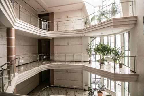 a large building with a staircase and plants in it at Карпаты in Khust