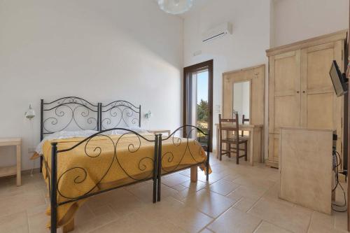 a bedroom with a bed and a table in a room at Agriturismo Podere San Giorgio in Otranto