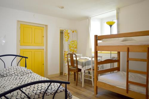 une chambre avec un lit et une salle à manger avec une table dans l'établissement La petite maison, à Grancey-le-Château
