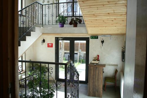 a staircase in a house with a wooden ceiling at Hotel Elite House in Mestia