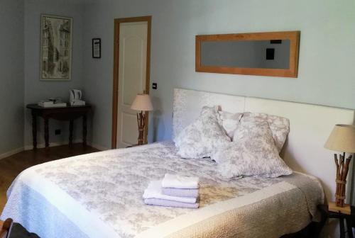a bedroom with a bed with towels on it at Le Domaine Des Platanes in Bourg-Charente