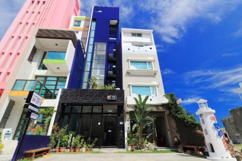 a tall building with a lighthouse in front of it at 36 Lighthouse in Hualien City