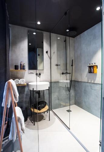 a bathroom with a shower and a sink at La Folie Douce Hotels Chamonix in Chamonix-Mont-Blanc