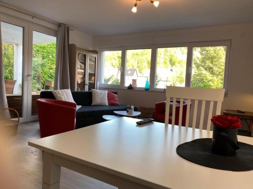 a living room with a table and chairs at Eifelblümchen in Heimbach