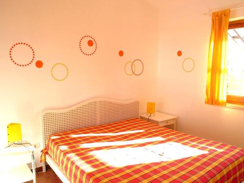 a bedroom with a bed with polka dots on the wall at Residence La Giungla in Falerna