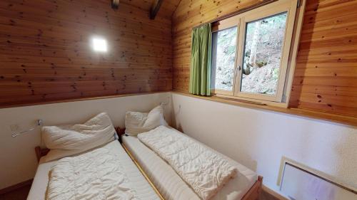 Postel nebo postele na pokoji v ubytování Tschuggen 59