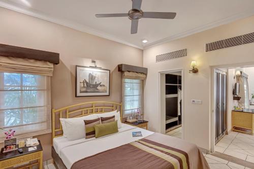 a bedroom with a bed and a ceiling fan at Club Mahindra Emerald Palms, Goa in Varca