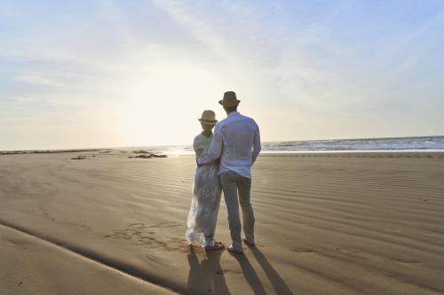 a man and a woman standing on the beach at Sofitel Essaouira Mogador Golf & Spa in Essaouira