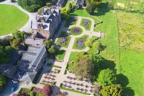 an aerial view of a mansion with a cross on the lawn at Newly Refurbished Self-Catering Lodge Sleeping 3 in Wexford