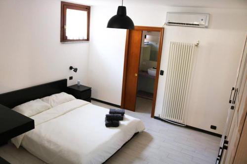 a bedroom with a bed and a door to a bathroom at LA CASA DEI NONNI in Pino Torinese