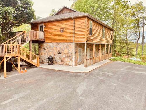 a log cabin with a staircase in front of it at Lazy Bear cabin in Sevierville