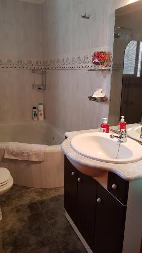 a bathroom with a sink and a toilet and a tub at Apartamento Mediterraneo in Pineda de Mar
