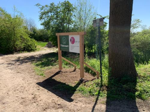 a sign in the dirt next to a tree at Pullevaart in Elim