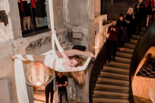 a woman in a white dress is dancing on the stairs at La Folie Douce Hotels Chamonix in Chamonix-Mont-Blanc