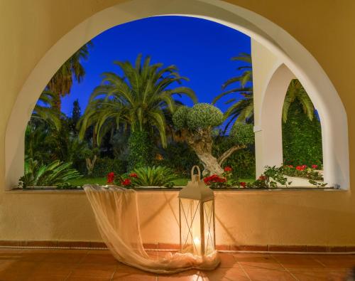 an archway with a window with flowers and plants at Villa Phoenix in Keri