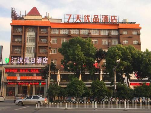 a large building with a sign on top of it at 7Days Premium Wuhan Caidian Plaza in Wuhan