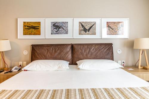 a bedroom with a large bed with two white pillows at Iu-á Hotel in Juazeiro do Norte
