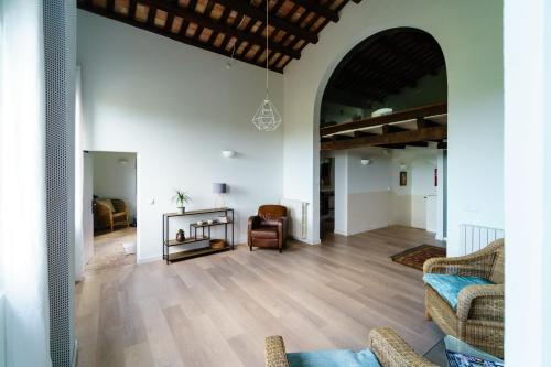 an open living room with a couch and a chair at Cal Germa at Can Campolier in Banyoles
