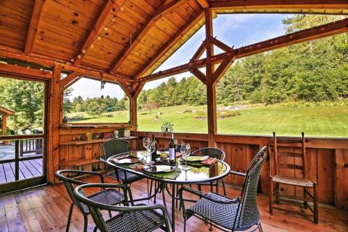 a patio with a table and chairs on a porch at Craftsbury Farmhouse in Craftsbury