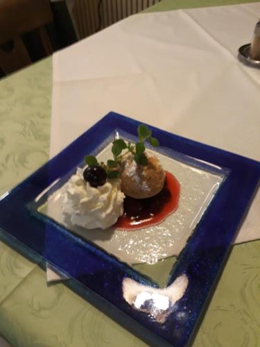 a blue plate with a dessert on a table at Turmhof Breitenbrunn in Breitenbrunn