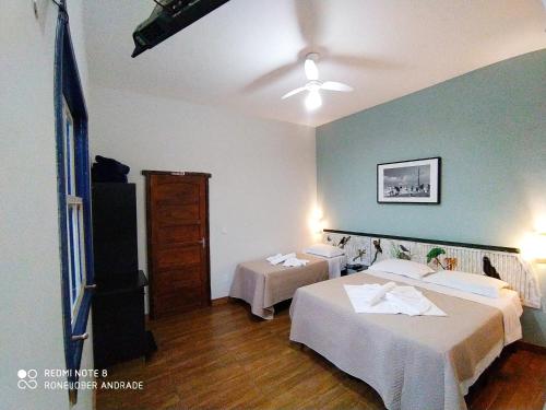 a hotel room with two beds and a ceiling at Pousada Ipoema in Ipoema