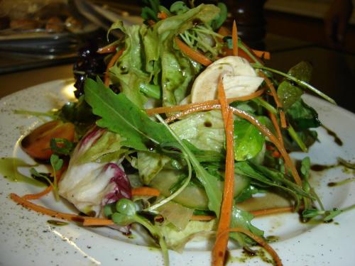 a salad on a white plate on a table at Turmhof Breitenbrunn in Breitenbrunn