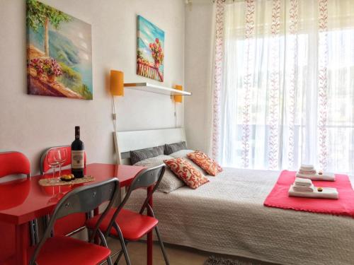 a bedroom with a bed and a red table and chairs at Apartment in Salerno Parco in Salerno