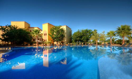 a large swimming pool in front of a resort at The Residences Vilamoura in Vilamoura
