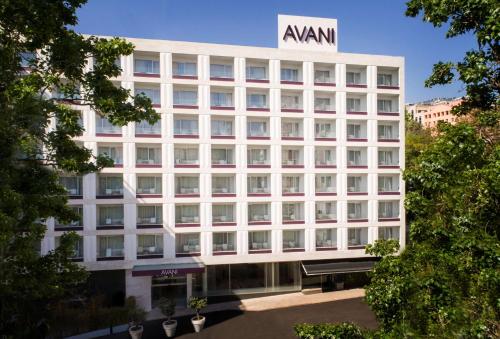 a large white building with a sign on the side of it at Avani Avenida Liberdade Lisbon Hotel in Lisbon