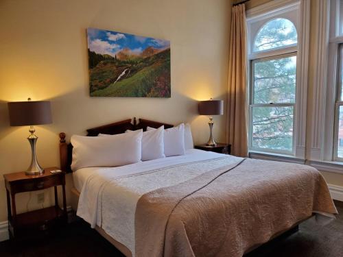 A bed or beds in a room at Hotel Ouray - for 12 years old and over