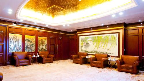 a large room with chairs and tables and a gold ceiling at Crowne Plaza Deqing Moganshan by IHG in Deqing